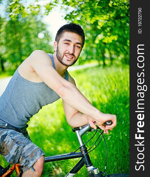 Young man cyclist sitting on bicycle