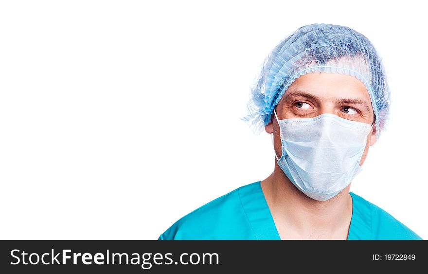 Portrait of a surgeon wearing a mask and green uniform and looking to the right. isolated on white background, copy space for your text to the right. Portrait of a surgeon wearing a mask and green uniform and looking to the right. isolated on white background, copy space for your text to the right