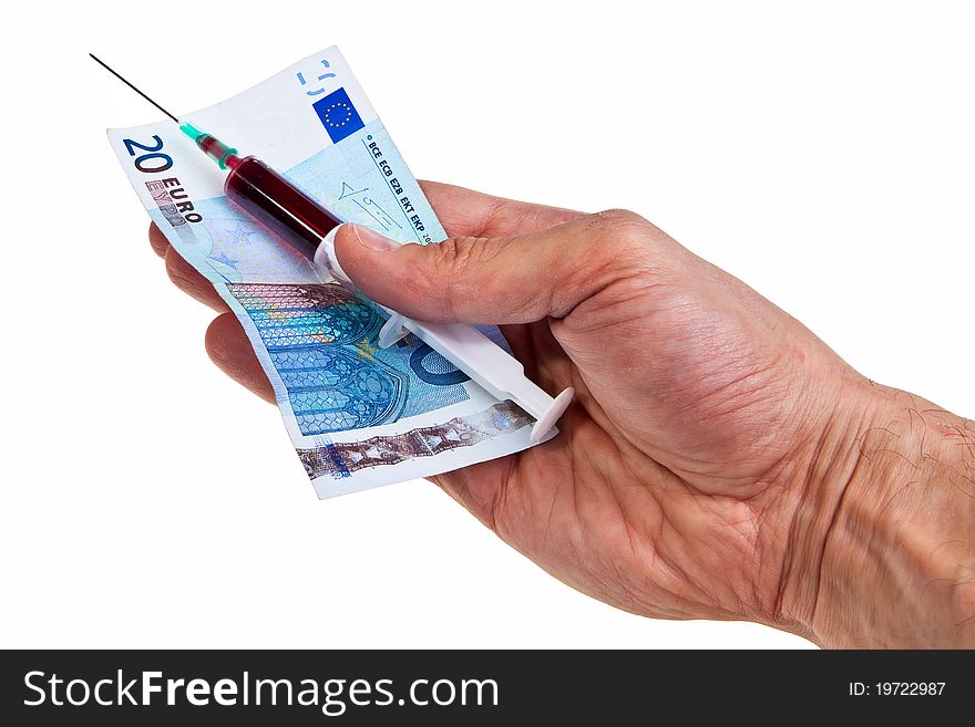 Syringe with red liquid and 20 Euro banknote hold by caucasian male hand over white background. Syringe with red liquid and 20 Euro banknote hold by caucasian male hand over white background.