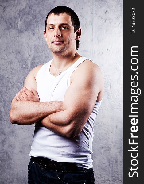 Portrait of a handsome muscular young man against the old wall. Portrait of a handsome muscular young man against the old wall