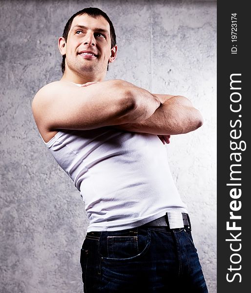 Portrait of a handsome muscular young man against the old wall. Portrait of a handsome muscular young man against the old wall