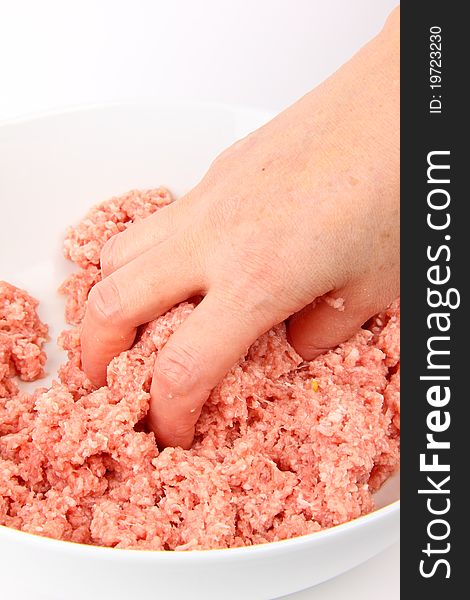 Hand working with minced meat. White background