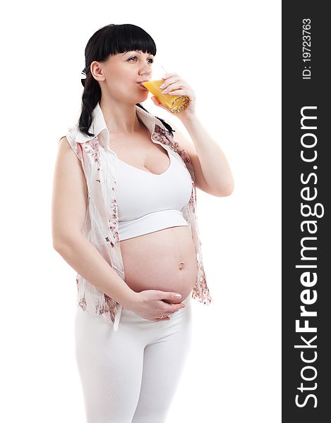 Pregnant woman with a glass of refreshing oranges juice on a white background