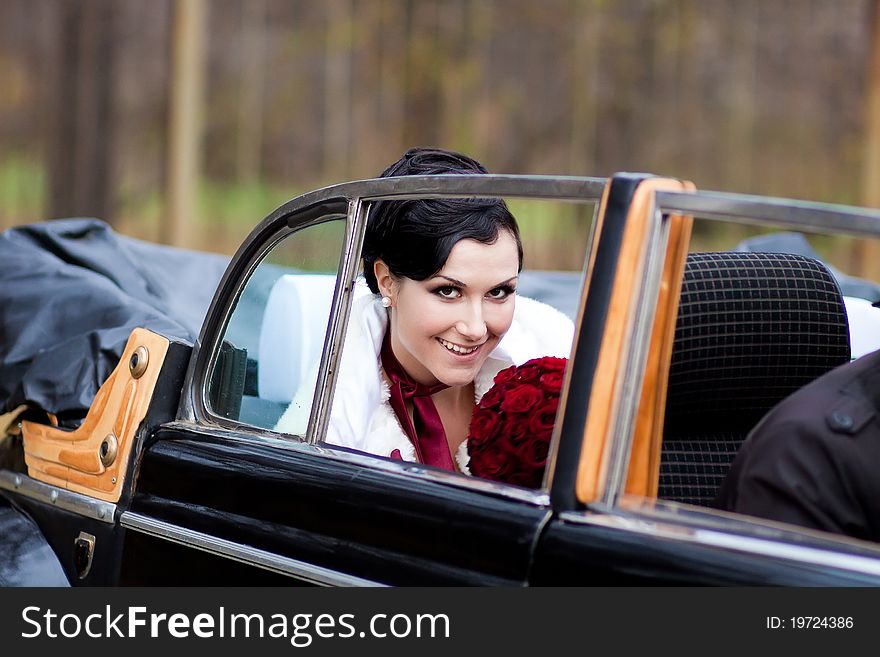 Beautiful bride in black retro car. Beautiful bride in black retro car