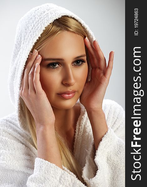 Atrractive blond young girl in a white bathrobe. Atrractive blond young girl in a white bathrobe