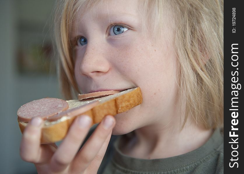 Boy eating sandwich