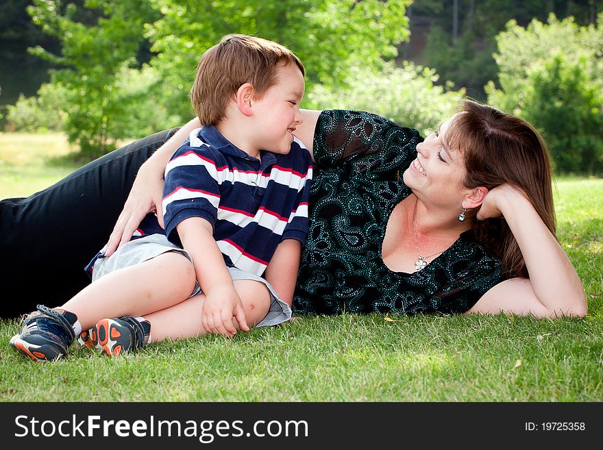 Mother And Son Play Outside On Field