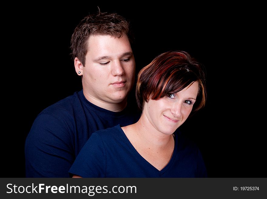 An isolated image of a young man and woman cople.  They are wearing blank t shirts so any text can be entered by the buyer. An isolated image of a young man and woman cople.  They are wearing blank t shirts so any text can be entered by the buyer.