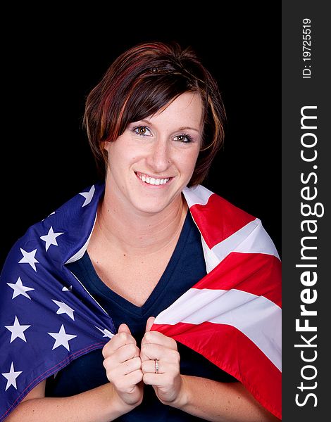 A nice image of a young lady smiling with the American Flag wrapped around her. A nice image of a young lady smiling with the American Flag wrapped around her.