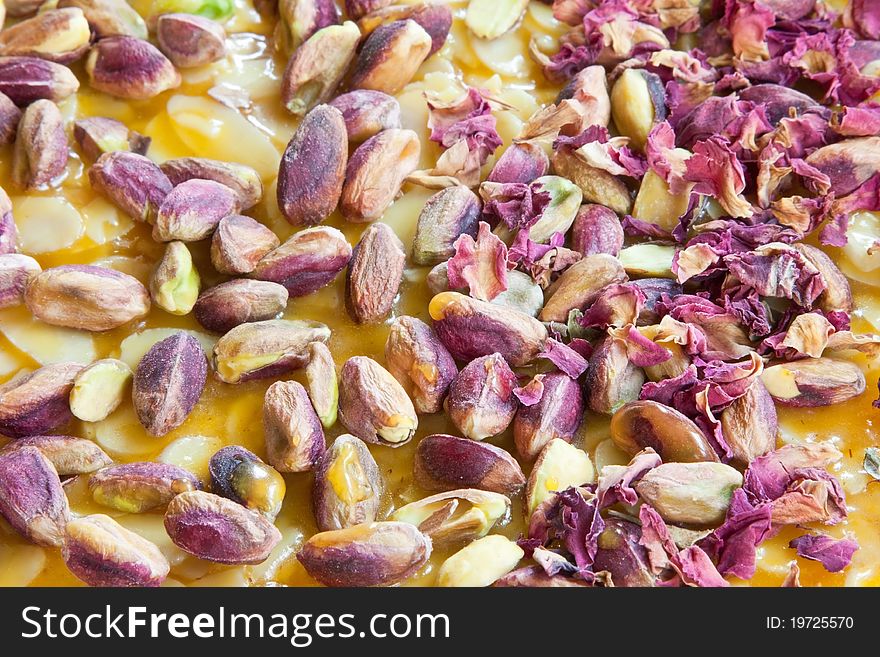 Pistachio & almond nut brittle garnished with edible rose leaves. Pistachio & almond nut brittle garnished with edible rose leaves