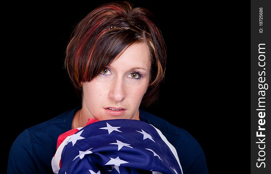 A nice image of a woman holding an American Flag.