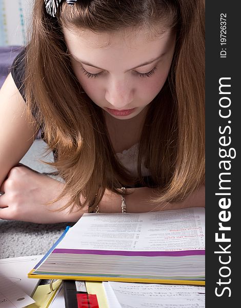 An extreme close-up of a cute girl in deep concentration while studying. An extreme close-up of a cute girl in deep concentration while studying