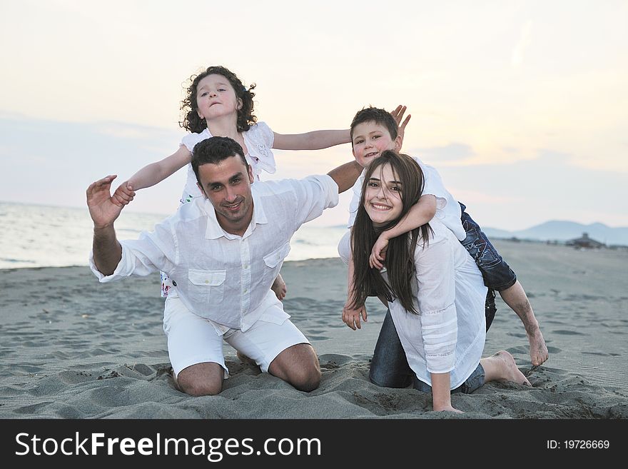 Happy young family have fun on beach run and jump at sunset. Happy young family have fun on beach run and jump at sunset