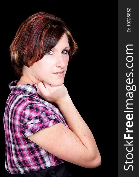 A young lady poses with her arm under her chin. A young lady poses with her arm under her chin.