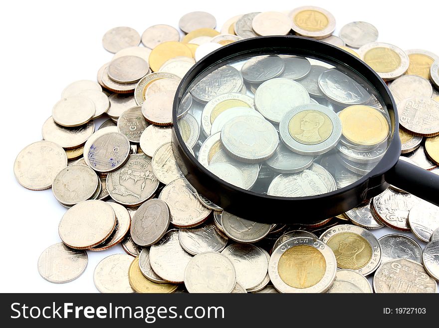 Magnifying glass and lots of gold coins