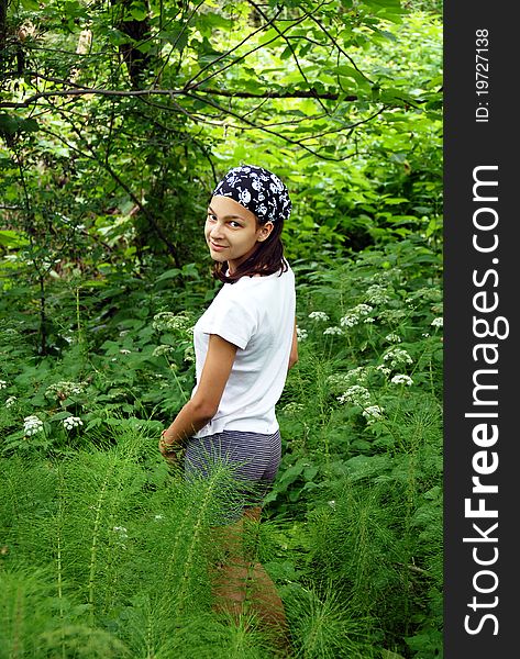 Beautiful smiling teenage caucasian girl in park over natural green background outdoors. Beautiful smiling teenage caucasian girl in park over natural green background outdoors