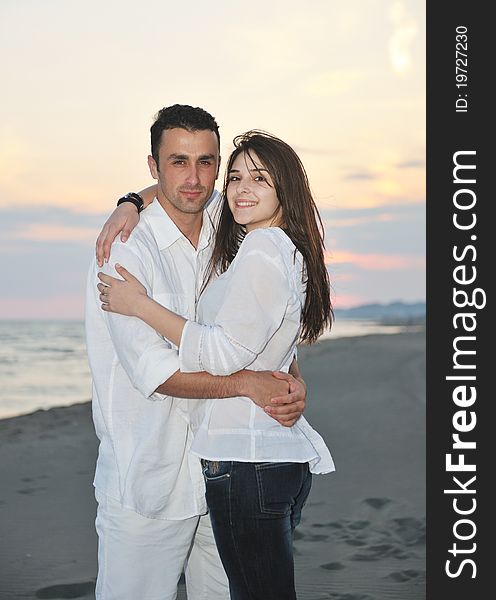 Happy young couple have fun and romantic moments on beach at summer season and representing happynes and travel concept. Happy young couple have fun and romantic moments on beach at summer season and representing happynes and travel concept