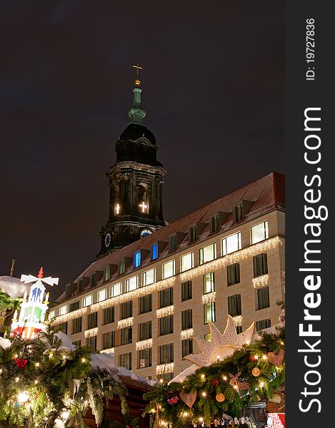 Christmas market in Dresden with tower of Kreuzkirche church.