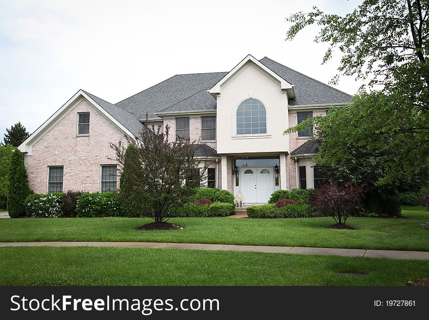 Image of a single family home with many windows and beautiful landscaping. Image of a single family home with many windows and beautiful landscaping.