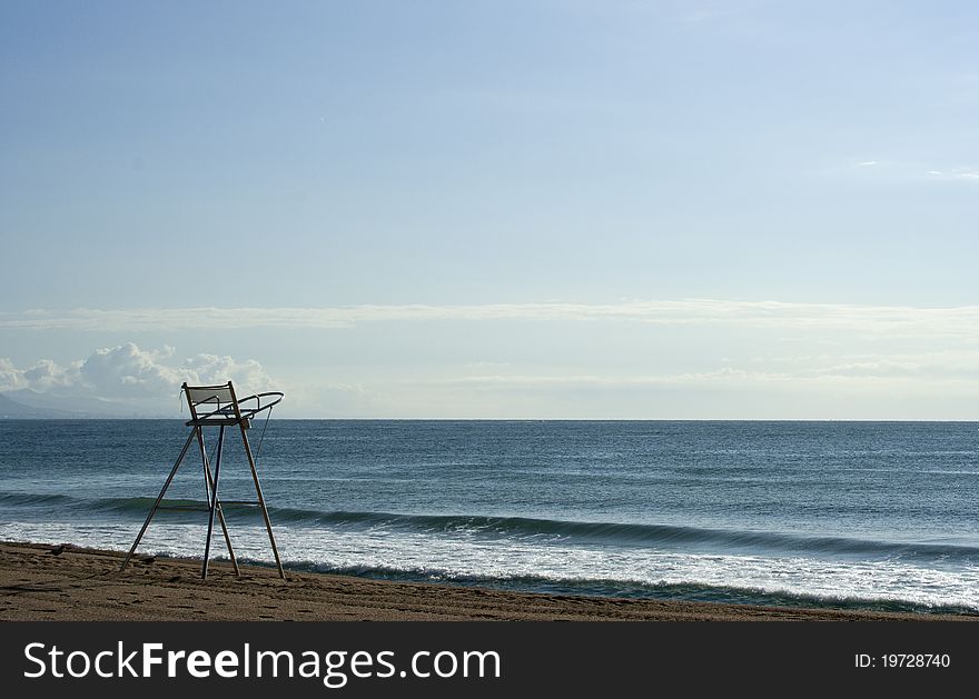 Lifeguard's chair on the beach in the morning, raw. Lifeguard's chair on the beach in the morning, raw