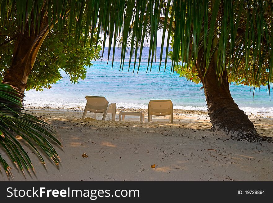 Chairs on tropical beach - abstract vacation background