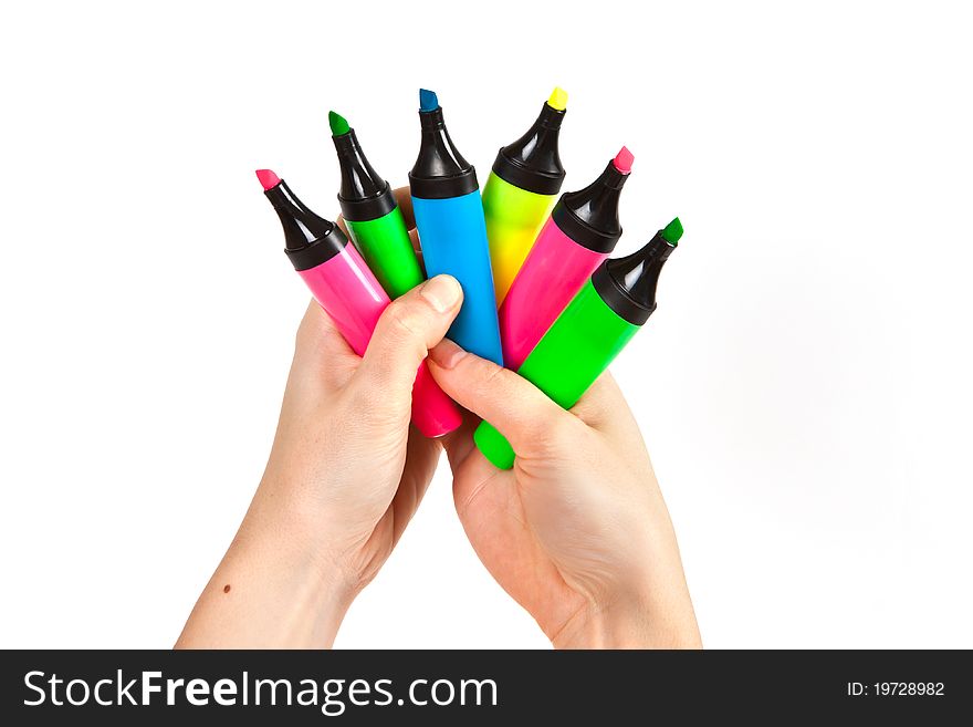 Hand holding colorful markers on white