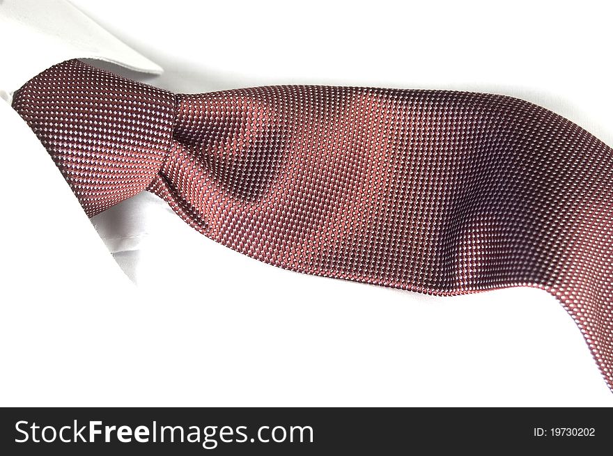 Corporate silk necktie with Windsor knot together with a white cotton shirt. Corporate silk necktie with Windsor knot together with a white cotton shirt.