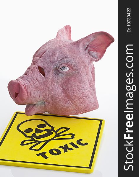 A swine mask and a toxic caution label on white background. A swine mask and a toxic caution label on white background