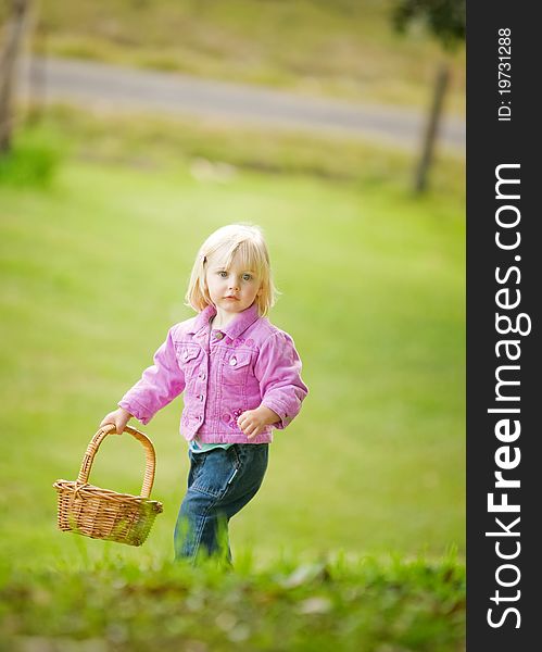 A cute little girl holding a basket