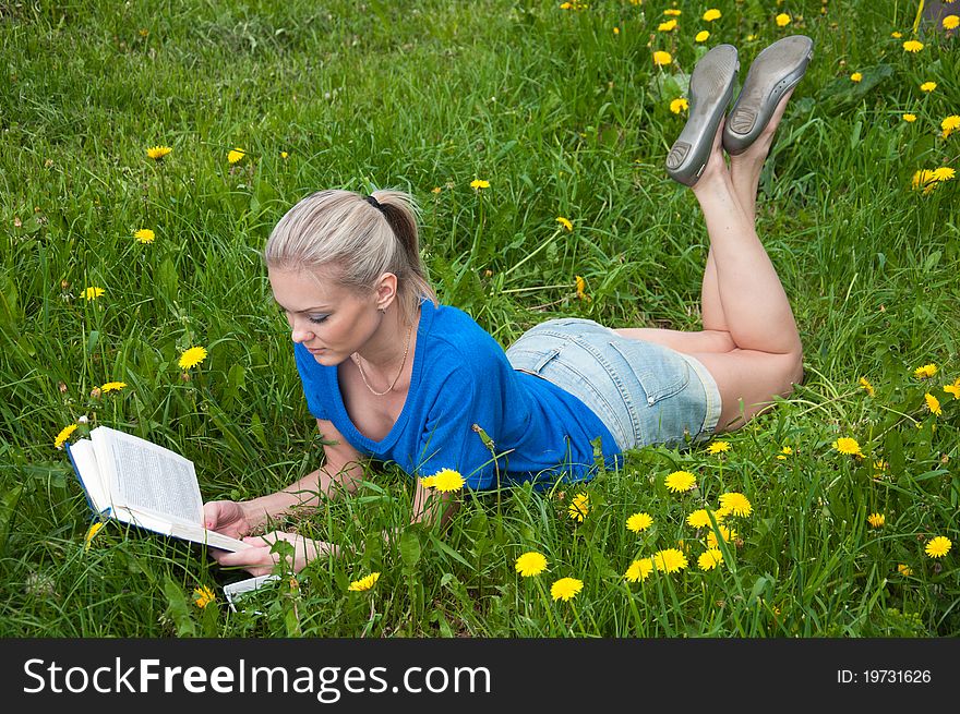 A girl student with a book in the park