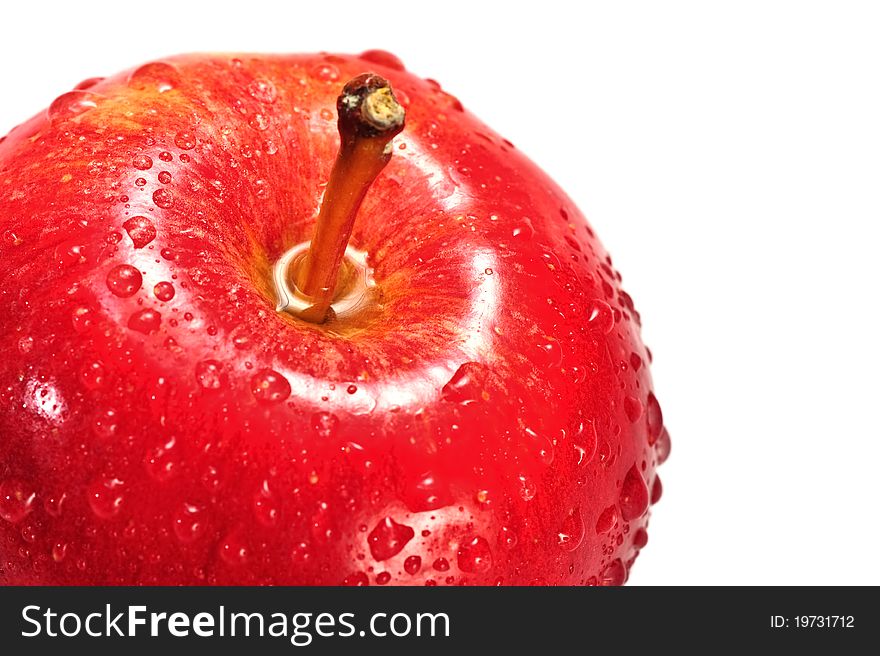 Fresh apple on isolated white background. Organic, healthy red delicious apple has drops of water on it, stem and slight shadow.