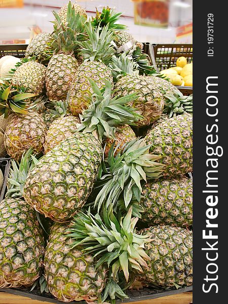 Pineapples stand in a supermarket