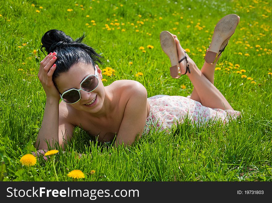 A young girl rests in a park, summer