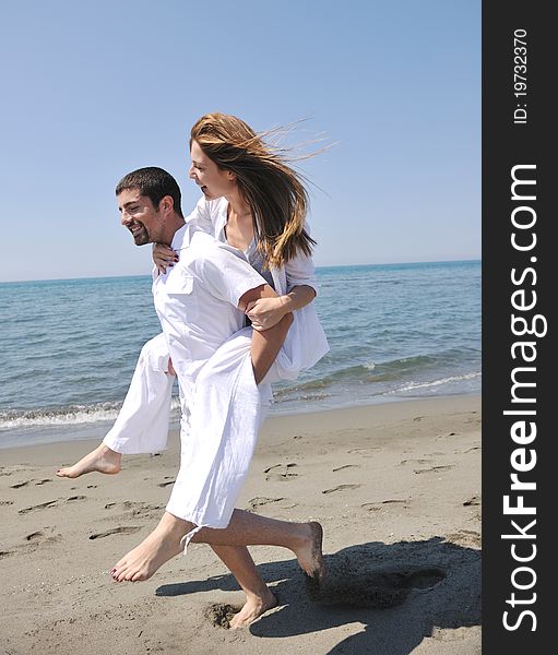 Happy young couple have fun and romantic moments on beach at summer season and representing happynes and travel concept. Happy young couple have fun and romantic moments on beach at summer season and representing happynes and travel concept