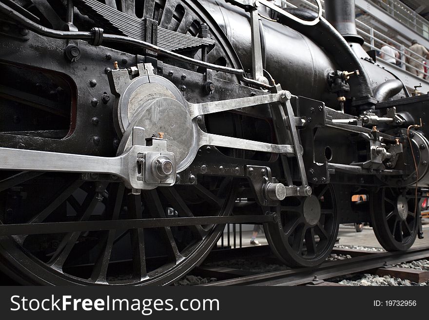 Closeup of vintage steam engine's black, iron wheel. Closeup of vintage steam engine's black, iron wheel