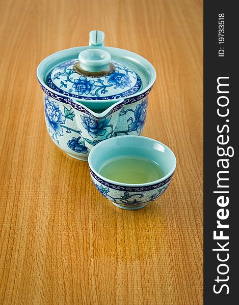 Tea mug in Chinese's style on wooden table. Tea mug in Chinese's style on wooden table