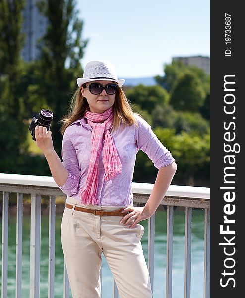 Blond woman with photocamera and cowboy's hat