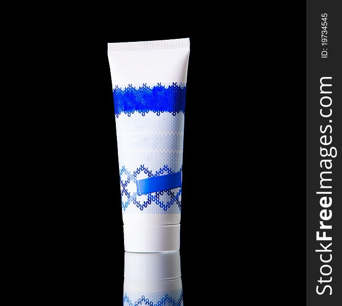 A tube of cream isolated on black background