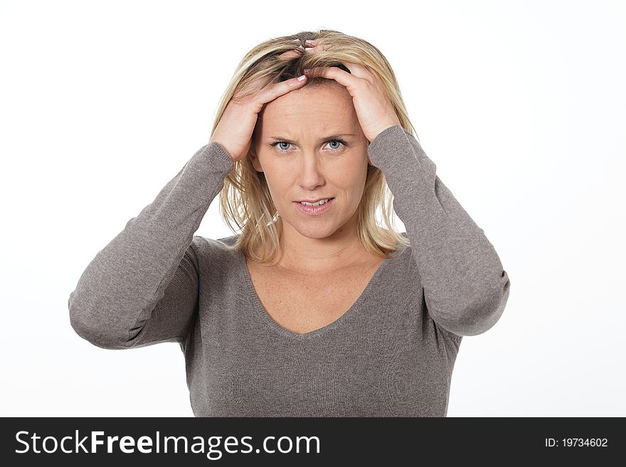 Beautiful blond woman in studio with head in the hands. Beautiful blond woman in studio with head in the hands