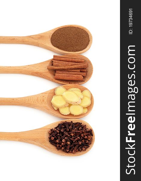 Cloves, fresh ginger, cinnamon sticks and ground allspice in wooden spoons isolated over white background. Cloves, fresh ginger, cinnamon sticks and ground allspice in wooden spoons isolated over white background.