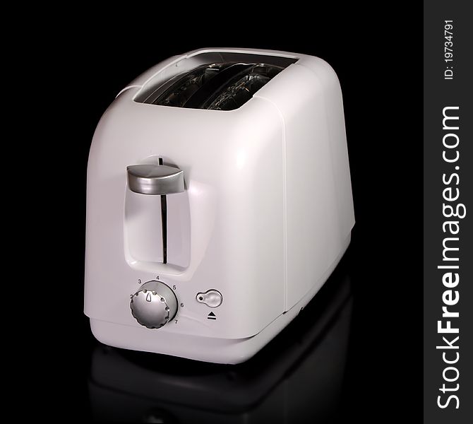 White plastic toaster isolated on a black background