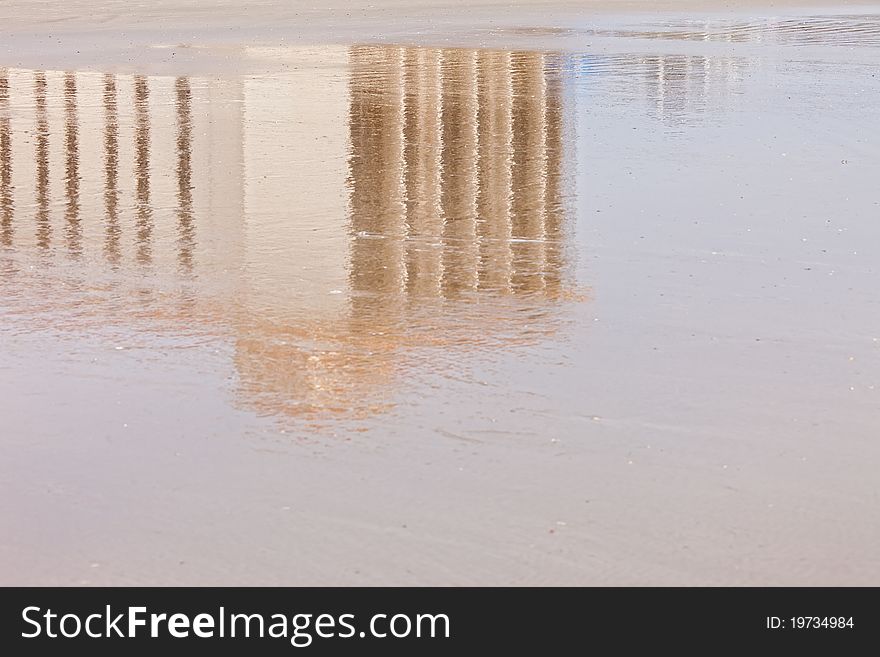 Reflection of building in wet sand