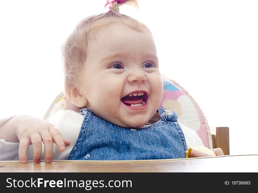 Little girl smiling. sits on a children's chair. white background. Little girl smiling. sits on a children's chair. white background
