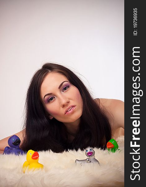 Funny girl portrait with colorful ducks toy