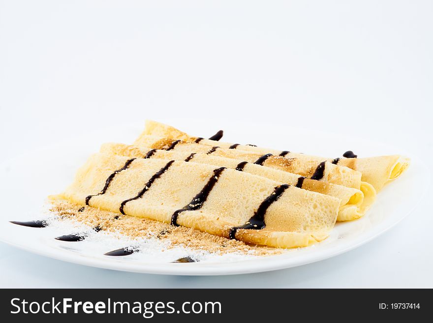 Pancakes with chocolate isolated on white background