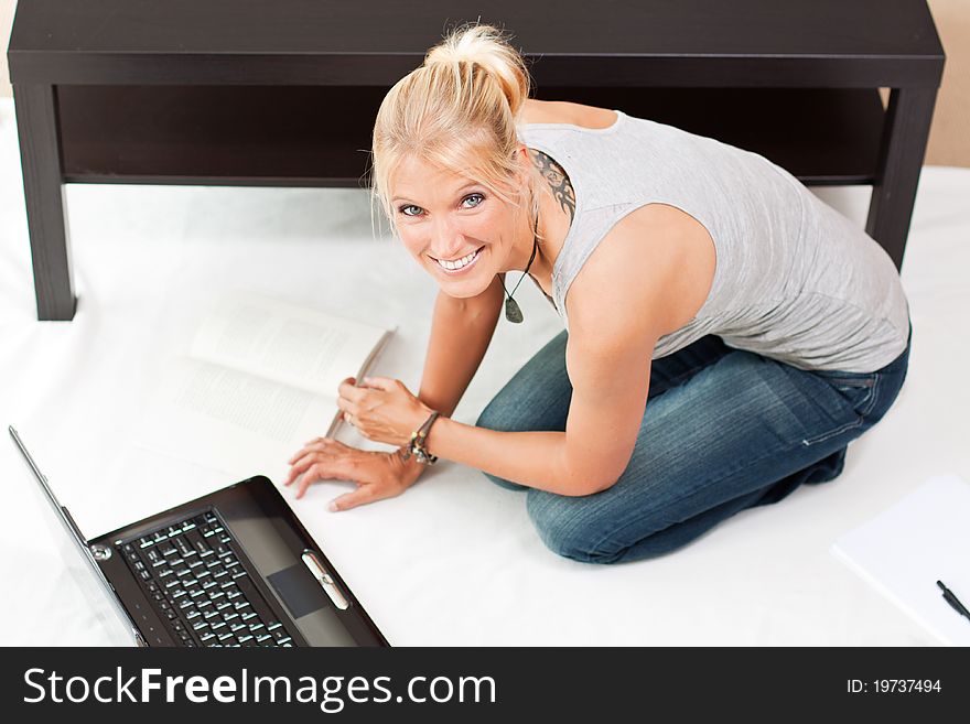 Young Attractive Woman Works On Her Laptop