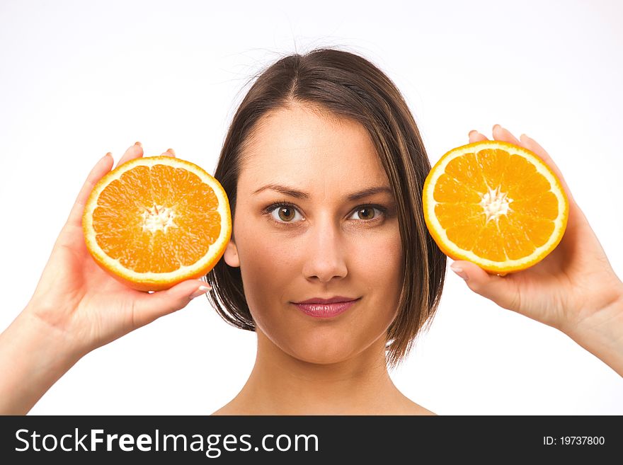 Young woman holding two halves of orange. Young woman holding two halves of orange