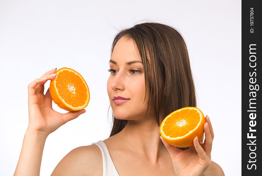 Young woman and two halves of orange