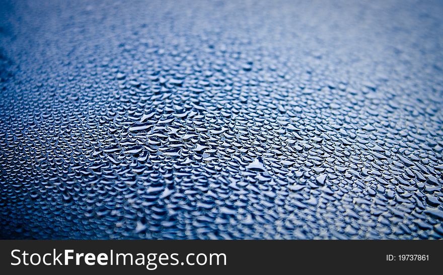 Abstract image of droplets of water condensation on metal