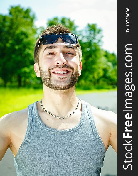 Young man smiling in park
